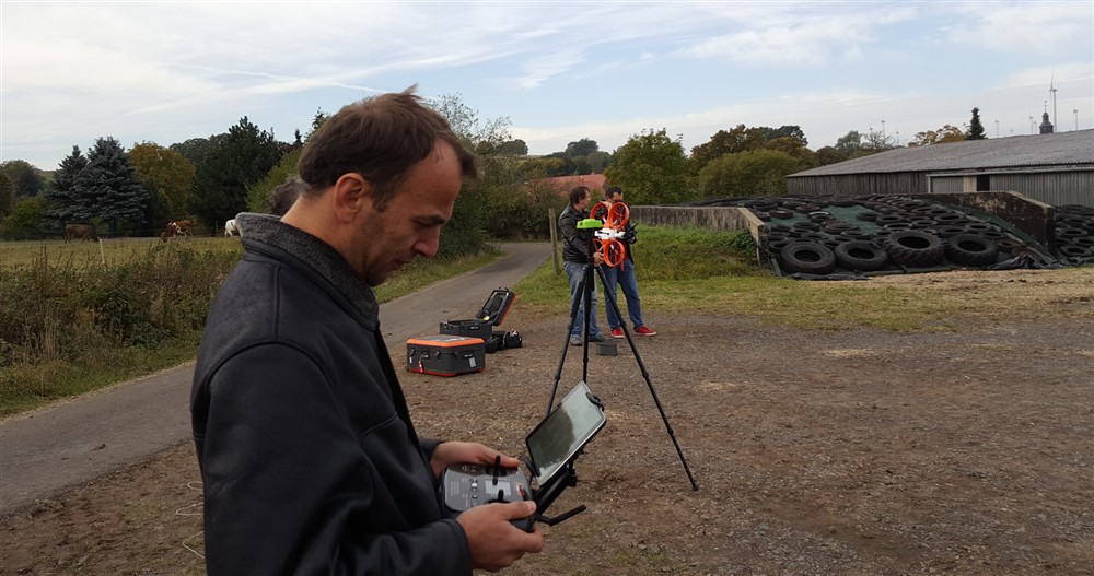 Field crew operating the controller during a drone flight